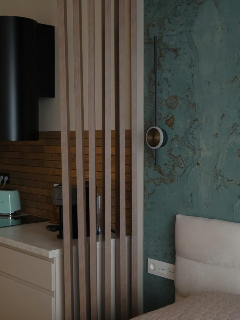 Chic apartment interior showcasing minimalist kitchen and stylish bedroom elements.